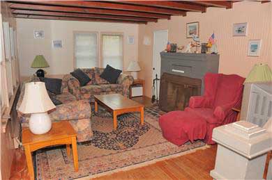 East Sandwich Beach.  Just off Cape Cod vacation rental - Living room with dune and ocean view and fireplace