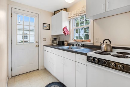 Dennis Port Cape Cod vacation rental - Kitchen with door to picnic table and outdoor shower
