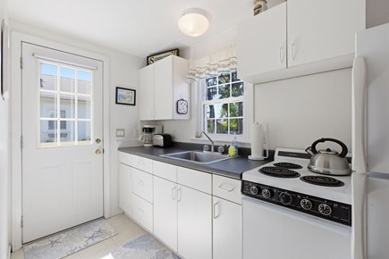 Dennis Port Cape Cod vacation rental - Kitchen with door to picnic table and outdoor shower