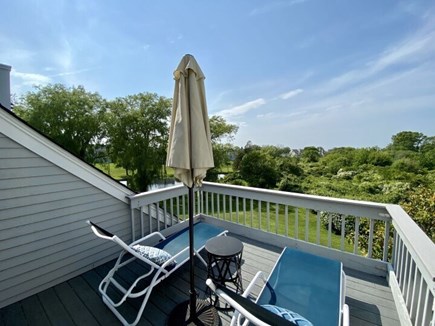 Ocean Edge Resort Cape Cod vacation rental - Primary bed w/ balcony overlooking pond & tree-lined ccean view