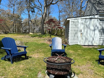 Brewster Cape Cod vacation rental - Firepit in expansive backyard surrounded by trees and fence!