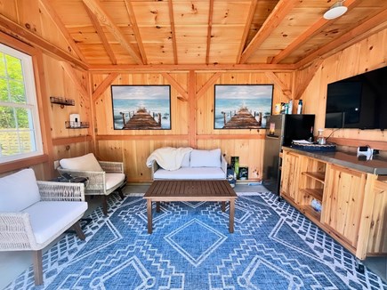 Harwich Cape Cod vacation rental - Pool shed with seating, fridge, and TV
