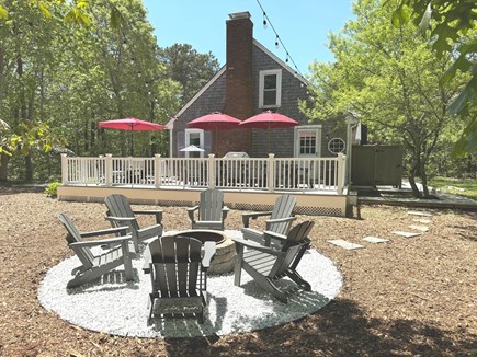 Eastham Cape Cod vacation rental - Firepit, large deck, sofa group, dining table, Weber grill.