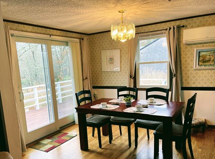 in East Falmouth, waterfront  Cape Cod vacation rental - Dining room: table with chairs, nice chandelier