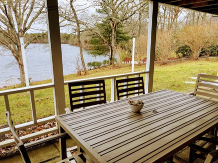 in East Falmouth, waterfront  Cape Cod vacation rental - View from patio. Table and chairs.