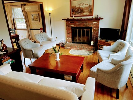 in East Falmouth, waterfront  Cape Cod vacation rental - Living room: TV set, fireplace, coffee table, chairs, sofa