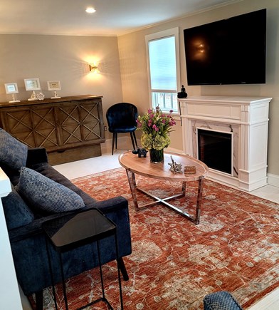 Dennis Cape Cod vacation rental - Living room with fireplace and queen sleeper sofa in cabinet