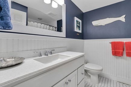 Dennis Cape Cod vacation rental - Main floor bathroom - single vanity with tub and shower curtain.