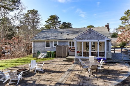 Dennis Cape Cod vacation rental - Back of house with three season room and outdoor shower.