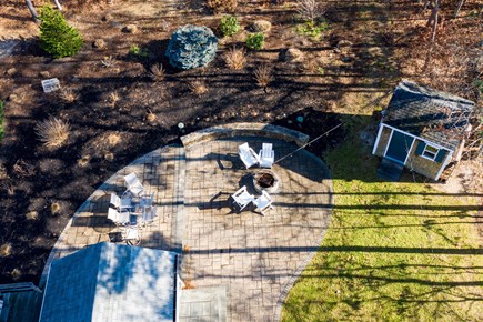 Dennis Cape Cod vacation rental - Backyard patio with dining area and firepit.