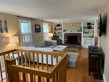 Eastham Cape Cod vacation rental - Living room with working fireplace and built in book cases
