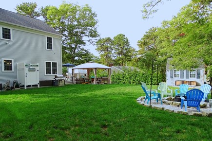 Dennis Cape Cod vacation rental - Large back yard with three places to relax, fire pit