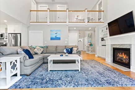 Falmouth Cape Cod vacation rental - Open concept living / dining and vaulted ceiling, gas fireplace