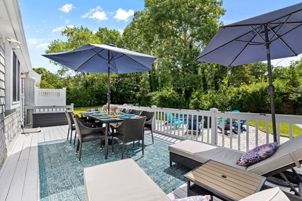 East Falmouth Cape Cod vacation rental - Enjoy dining or lounging on the back deck.