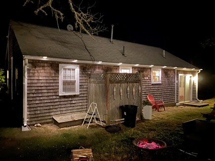 West Dennis Cape Cod vacation rental - Backyard bonfire oasis with newly installed lighting.