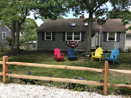 West Dennis Cape Cod vacation rental - Quiet, shaded front yard with colorful Adirondack Chairs