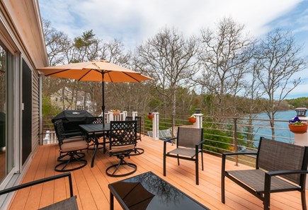 Sandwich Cape Cod vacation rental - Upper deck with dining table, seating and pond views