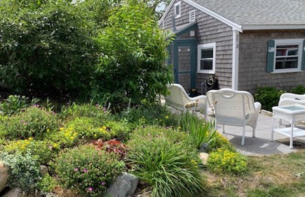 Dennis Port   Cape Cod vacation rental - Wicker furniture on bluestone patio with perennial garden