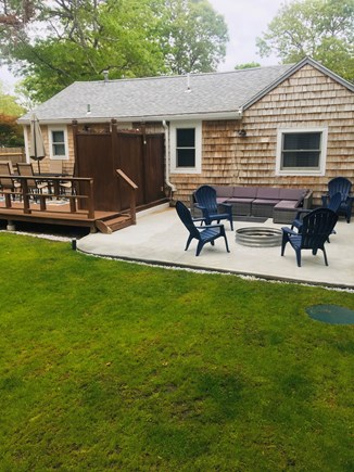 Yarmouth Cape Cod vacation rental - Large backyard and patio with firepit