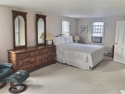 East Orleans/Nauset Beach Cape Cod vacation rental - Primary bedroom with king bed, ensuite bathroom, and AC
