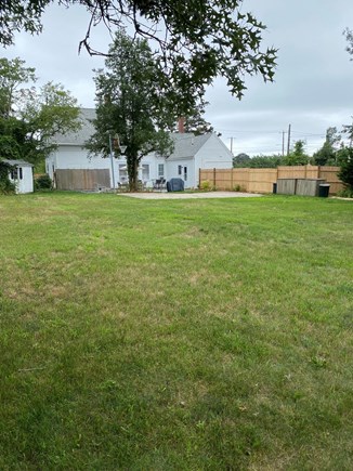 Dennis Port Cape Cod vacation rental - Fenced in yard with basketball court, patio, two outdoor showers