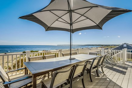 Centerville, Craigville Beach Road Cape Cod vacation rental - Large dining table with large umbrella on the deck.
