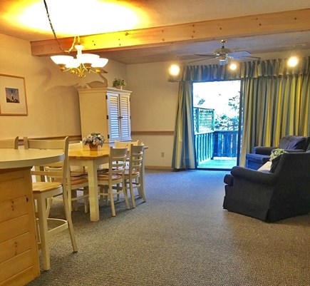 Mashpee Cape Cod vacation rental - Kitchen, dining area, & living room with sliders to the back deck