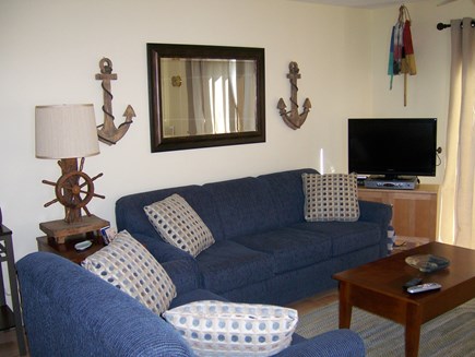 Provincetown Cape Cod vacation rental - Living room area with couch, chair, lift-top coffee table and TV