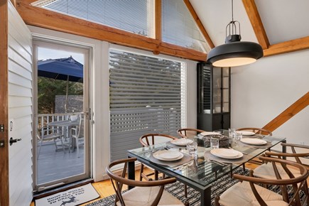 Barnstable Cape Cod vacation rental - Large bright windows lead out to deck from dining space.