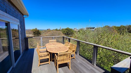 Truro Cape Cod vacation rental - Front deck with water views has dining table and chairs