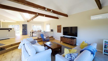 Truro Cape Cod vacation rental - Main living area with water view, vaulted ceiling & exposed beams