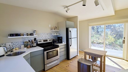 Truro Cape Cod vacation rental - Nicely equipped kitchen with slider to back deck with gas grill