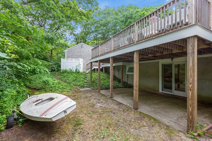 West Yarmouth Cape Cod vacation rental - Back of house with access to walk-out basement and path to deck