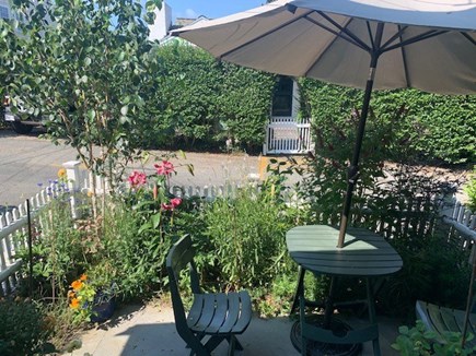 East End Provincetown Cape Cod vacation rental - Garden looking out on street. Covered porch and cottage behind.