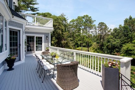 Osterville Cape Cod vacation rental - Large deck with ample seating overlooking back yard and pond