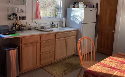 Provincetown, Historic East End, independent Cape Cod vacation rental - Cabinets and window above sink, and bathroom door