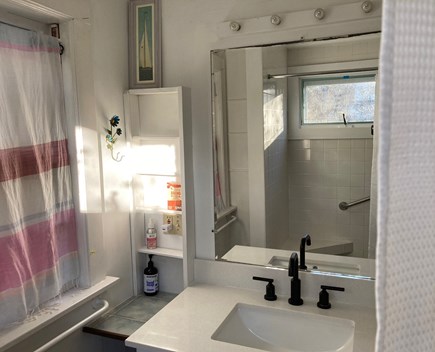 Provincetown, Historic East End, independent Cape Cod vacation rental - Bathroom sink, tiled shower with seat and bar in mirror