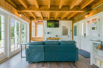 East Sandwich Cape Cod vacation rental - View of living room looking toward upstairs and bathroom door.