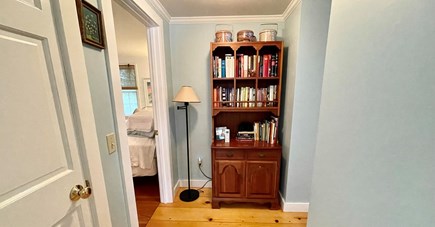 West Barnstable - off Route 6A Cape Cod vacation rental - Hallway bookshelf full of local & classic reads, and board games.