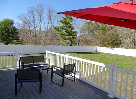 Hyannis, Barnstable Cape Cod vacation rental - Deck area with grill, overlooking large fenced yard 