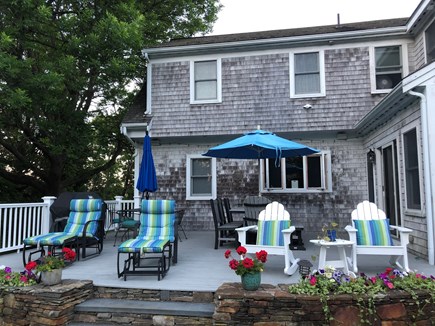 Eastham Cape Cod vacation rental - Back deck with 2 tables with umbrellas, and gas grill