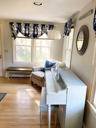 Eastham Cape Cod vacation rental - Piano in kitchen dining area with a comfy club chair