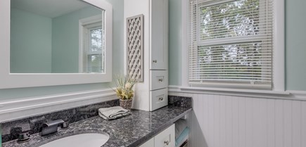South Yarmouth Cape Cod vacation rental - Bathroom view of vanity with ample storage and towels.