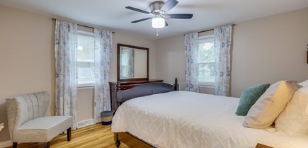 South Yarmouth Cape Cod vacation rental - Master bedroom, view of dresser and additional seating.