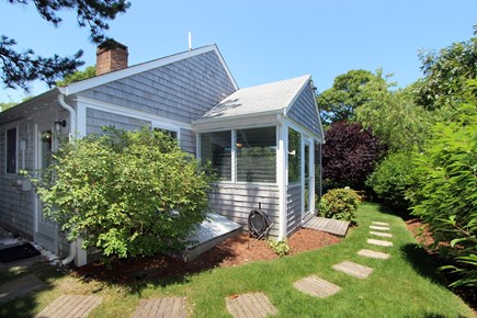 Brewster Cape Cod vacation rental - Side yard with door to sunroom.