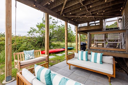 Truro Cape Cod vacation rental - Lower deck with bench swing, lounge seating and twinkle lights