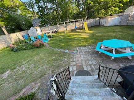 East Falmouth Cape Cod vacation rental - Backyard with fire pit, swing set,picnic table and outdoor shower