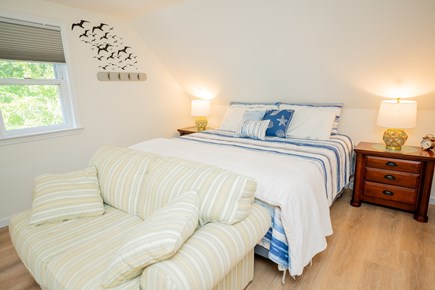 Harwich Cape Cod vacation rental - CAPT's Quarters - bedroom with king bed, loveseats, and 42 in tv.