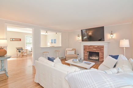 Harwich Port Cape Cod vacation rental - Living room with fireplace and bar.