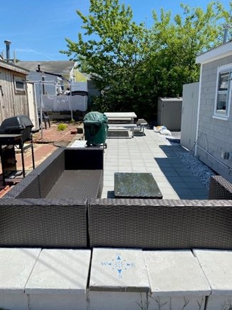 Dennis Port Cape Cod vacation rental - Large back patio with gas grill, picnic table, and sectional sofa